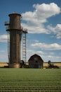 Farm With Silo and Barn in the Background. Generative AI. Royalty Free Stock Photo