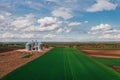 Farm silos in field, aerial view from drone pov