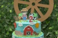 Farm theme boy birthday cake. Beautiful decorated cake. Farmer, barn, donkey, cow and chicken. Selective focus. 2 year anniversary Royalty Free Stock Photo