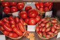 Farm tomatoes in a basket lie in the window of the farmer`s market. The latest hybrid varieties of vegetables Royalty Free Stock Photo