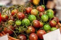 Farm tomatoes in a basket lie in the window of the farmer`s market. The latest hybrid varieties of vegetables Royalty Free Stock Photo