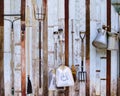 Farm tool pitchfork and two shovels against old wooden wall use Royalty Free Stock Photo