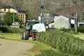 Farm tractor with baler wrapper working in rural area