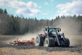 Farm Tractor and Cultivator on Field at Spring