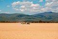 Farm tractor drives in field