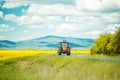 Farm tractor drives on road Royalty Free Stock Photo