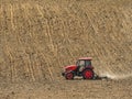 Farm tractor harrowing arable field