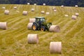 Farm tractor moving hay bales