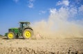 Farm tractor preparing dusty soil affected by drought Royalty Free Stock Photo