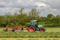 A farm tractor with rota rake ready to make silage
