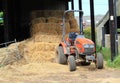 Farm tractor and straw bales.