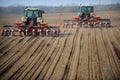 Farm tractors planting field