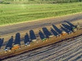 Farm Tractors working on sugar cane harvest plantation aerial view