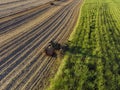 Farm Tractors working on sugar cane harvest plantation aerial view Royalty Free Stock Photo