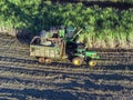 Farm Tractors working on sugar cane harvest plantation aerial view Royalty Free Stock Photo