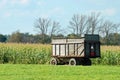 Farm trailer by a corn field