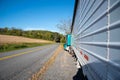 Farm truck tractor trailer on rural asphalt road by ripe soybean field Royalty Free Stock Photo