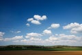 Farm under bright sky with little clouds