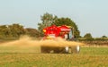 Farm Vehicle spreading lime sandstone onto a field Royalty Free Stock Photo