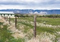 Farm view of Big Horn mountains from Shell, Wyoming. See moraines and old farm building with fence.