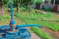 Farm village county water well with hand manual pump. Old utility supply facilities. Country lifestyle image. Primitive mechanism Royalty Free Stock Photo
