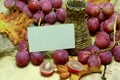 Farm wine wicker bottle and grapes with card Royalty Free Stock Photo