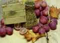 Farm wine wicker bottle and grapes with label Royalty Free Stock Photo