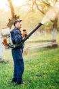 farm worker gardening and spraying pesticide