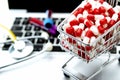 shopping cart with white and red capsules in the foreground