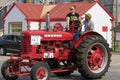 A FARMALL Farm tractor in the Czech Fest parade driving on the street