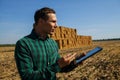 Farmer agronomist with digital tablet computer using mobile app in wheat crops field