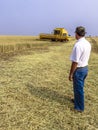 Farmer analyzing worl of combine harvester