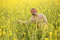 Farmer with arms outstretched in rapeseed field Royalty Free Stock Photo