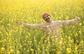 Farmer with arms outstretched in rapeseed field Royalty Free Stock Photo