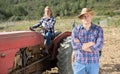 Farmer on background with wife on tractor Royalty Free Stock Photo