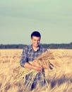 Farmer with barley stems in field