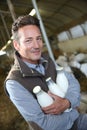 Farmer with bottles of fresh milk Royalty Free Stock Photo