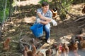 Farmer with bucket on poultry farm