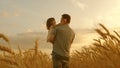 Farmer carries a little daughter in his arms through a field of wheat. happy child and father are playing in field of Royalty Free Stock Photo