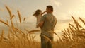 Farmer carries a little daughter in his arms through a field of wheat. happy child and father are playing in field of Royalty Free Stock Photo