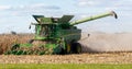 A farmer combining a field of corn Royalty Free Stock Photo