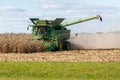 A farmer combining a field of corn in his John Deere combine harvester Royalty Free Stock Photo