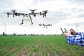 Farmer control agriculture drone fly to sprayed on corn field
