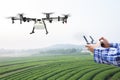 Farmer control agriculture drone fly to sprayed on tea field