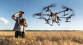 Farmer controls drone sprayer with a tablet.