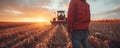 Farmer controls heavy machinery working on agricultural land. Man oversees every aspect of operation with precision and Royalty Free Stock Photo