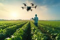 A farmer controls an innovative drone in a field with a crop. Artificial intelligence in agriculture