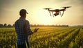A farmer controls a quadcopter drone in a green corn field. Innovation in agriculture Royalty Free Stock Photo