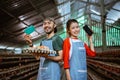 farmer couple carrying cardboard tray showing saving book and phone