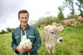 Farmer with cows holding bottles of fresh milk Royalty Free Stock Photo